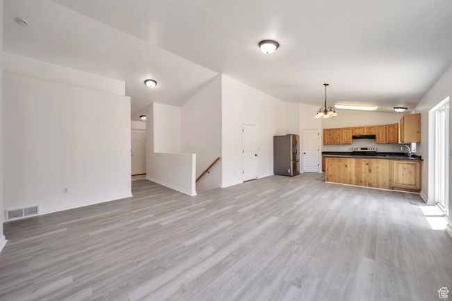 Featuring vaulted ceilin, g LVP flooring, a chandelier | Image 5