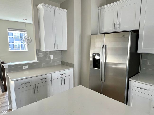 Gourmet chef's kitchen with SS appliances, gas range, Shelf Genie cabinet system, quartz countertops. | Image 18