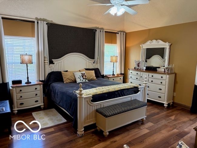 bedroom featuring multiple windows, ceiling fan, and dark wood-type flooring | Image 11