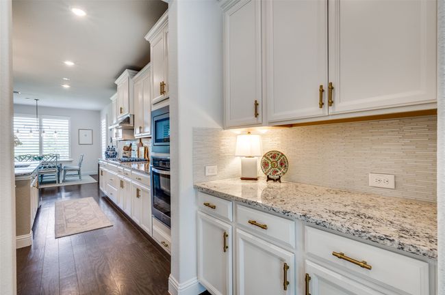 Butler station makes diner prep a breeze or great place for a dry bar. Located as the pass through between the formal dining and kitchen with easy access to the pantry. | Image 12