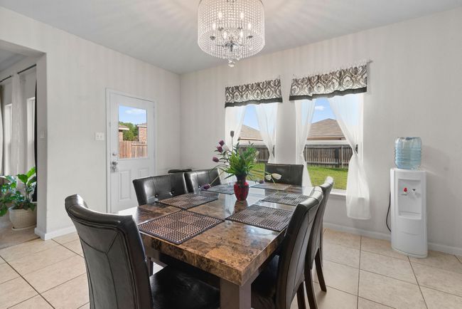 Dining area with a wealth of natural light, a chandelier, and light tile patterned flooring | Image 11