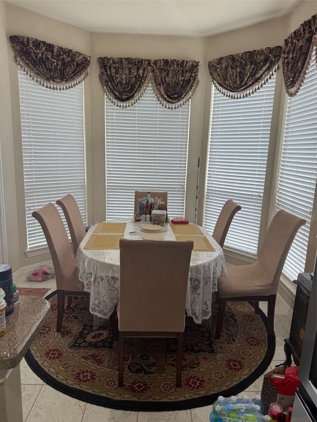 Dining space with light tile patterned floors | Image 17
