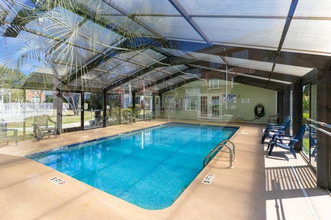 Pool with a lanai, a patio area, fence, and french doors | Image 22
