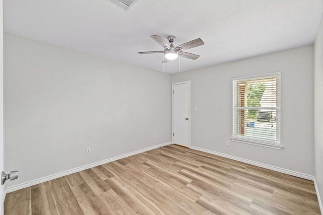 Empty room featuring light wood-type flooring, baseboards, and ceiling fan | Image 25