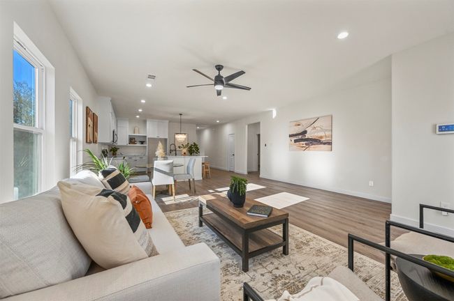 Living room with light wood-type flooring, recessed lighting, a ceiling fan, and baseboards | Image 13