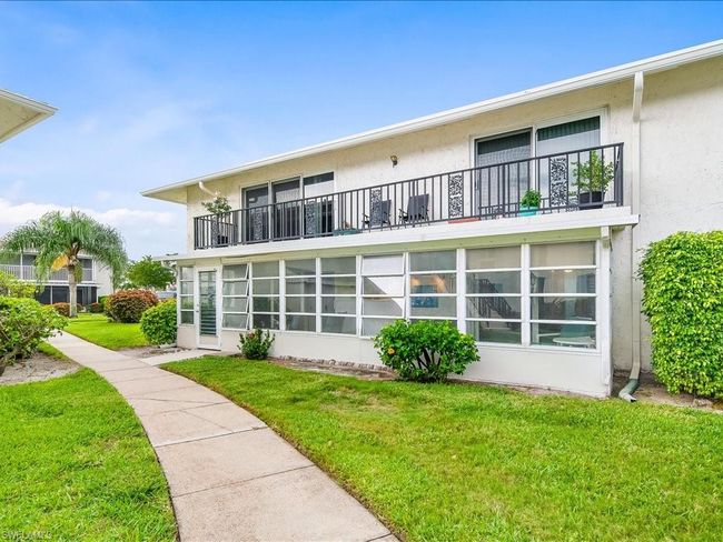 Back of house featuring a yard, a sunroom and a balcony | Image 18