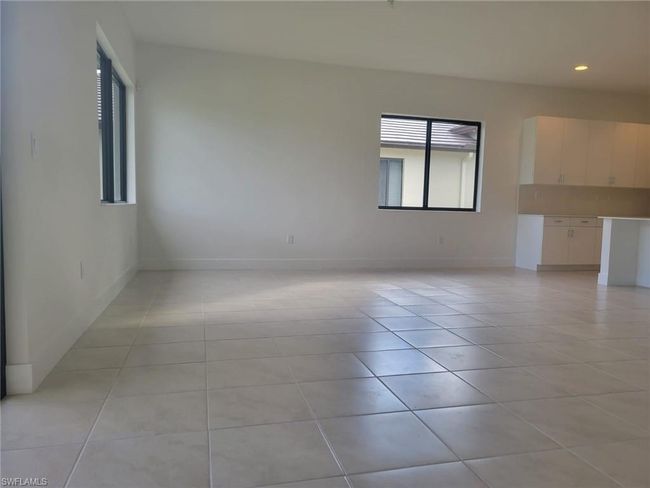Spare room with light tile patterned floors, baseboards, and recessed lighting | Image 7