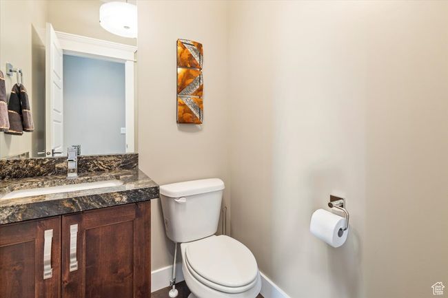 Bathroom with toilet, vanity, and baseboards | Image 19