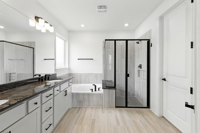Full bath featuring a garden tub, a stall shower, double vanity, and recessed lighting | Image 18