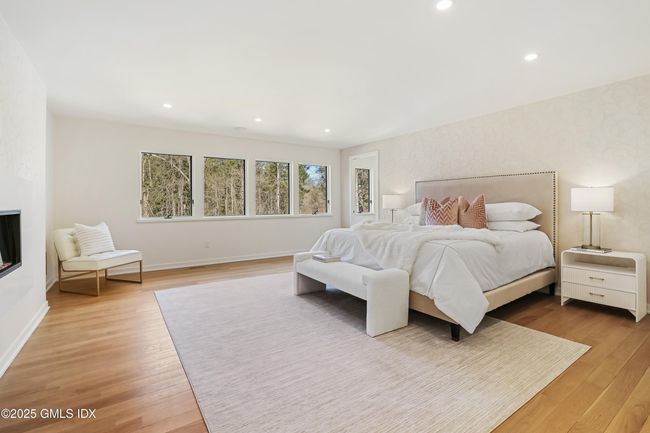 Primary bedrm, Fireplace and entrance to sitting area leading to priv deck w hot tub and spa-like bathroom | Image 25