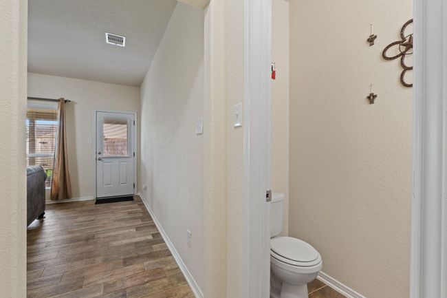 On your way to the primary is a half bathroom for guests. | Image 18