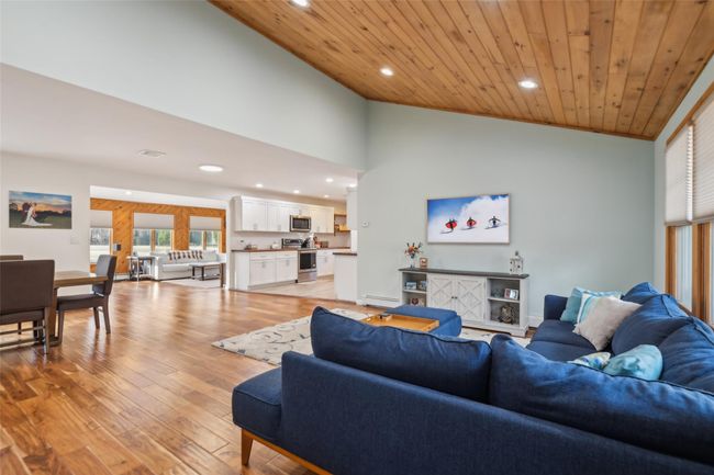 Living area featuring recessed lighting, light wood-style floors, wooden ceiling, and high vaulted ceiling | Image 7