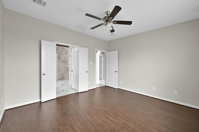 Inside the Primary Bedroom. Primary Bath to the left, and the Living area on the right | Image 19