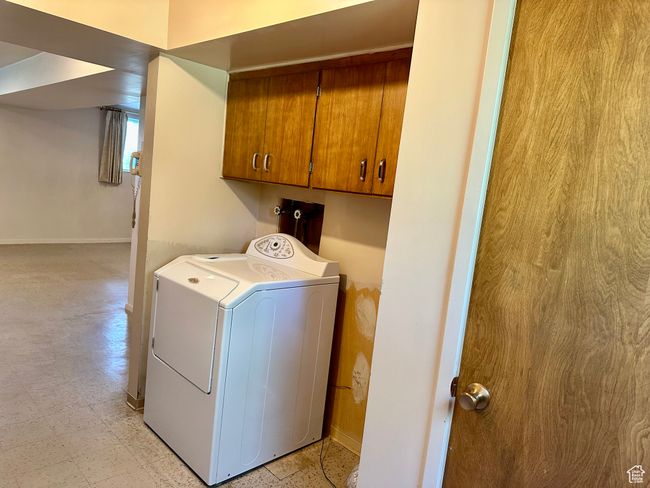 Washroom with washer / clothes dryer and cabinet space | Image 20