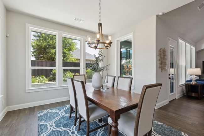 Dining space featuring a chandelier and dark wood-style floors | Image 14