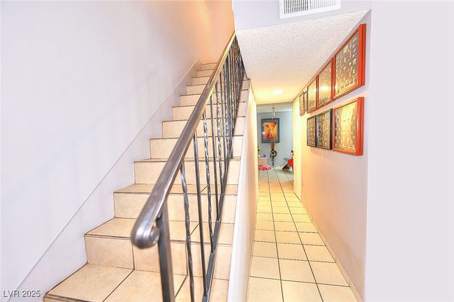 Stairs featuring tile p floors | Image 8