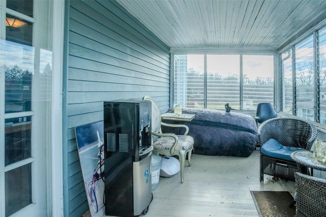 Sunroom with plenty of natural light and wooden ceiling | Image 24