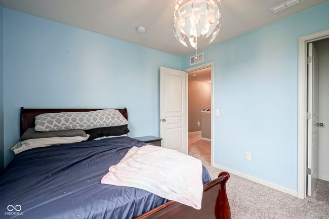 bedroom with a chandelier, carpet floors, and baseboards | Image 30