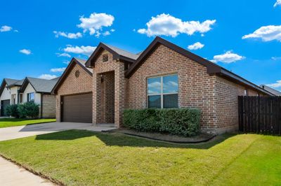 View of front of home featuring a garage and a front lawn | Image 2