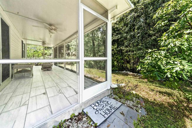Unfurnished sunroom featuring a ceiling fan | Image 32