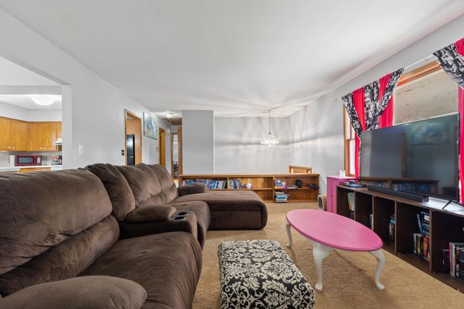The living room is large and features built in storage! | Image 7