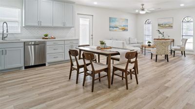 Dining area with ceiling fan, light wood-type flooring, and sink | Image 1