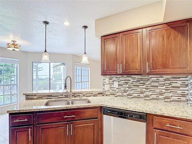 Granite counter tops and beautiful backsplash | Image 13