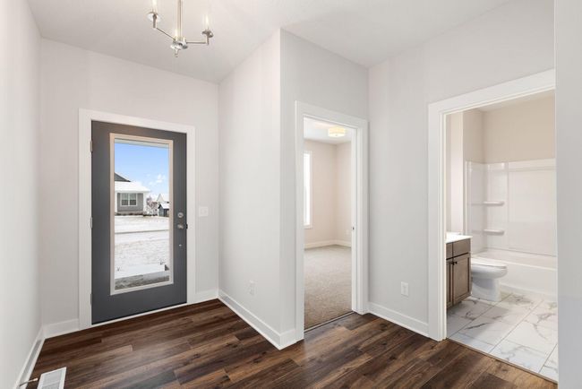Enter through the front door into a bright and airy foyer, showcasing sleek finishes, ample space, and a seamless flow into the heart of the home. This entryway is the perfect introduction to the home's modern charm and thoughtful layout. | Image 4