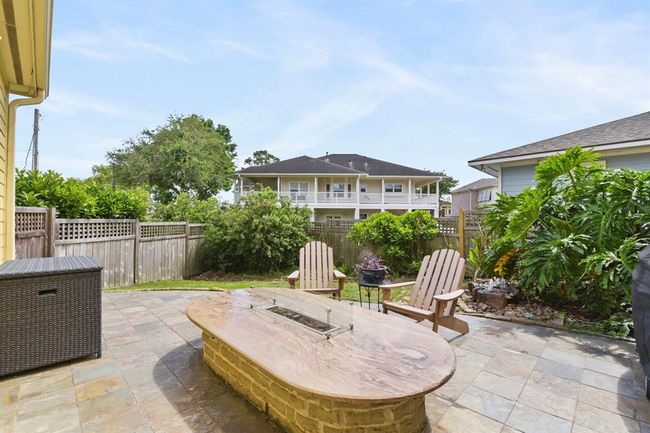 Cozy up by the outdoor gas fireplace, perfect for relaxing on chilly nights. | Image 40