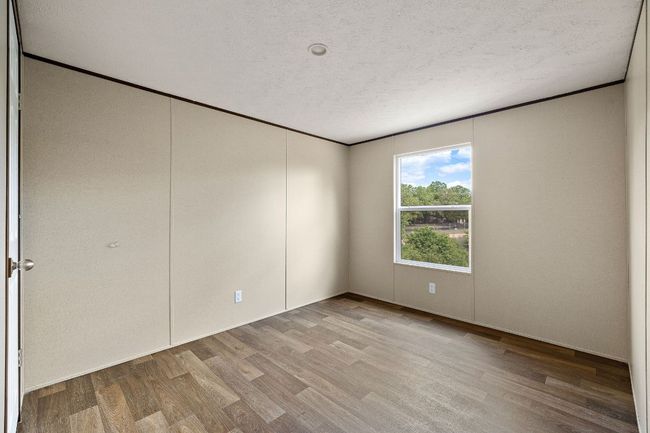Spare room featuring wood finished floors and ornamental molding | Image 29