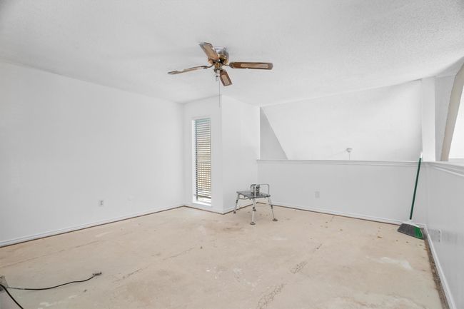Spare room featuring ceiling fan and baseboards | Image 11