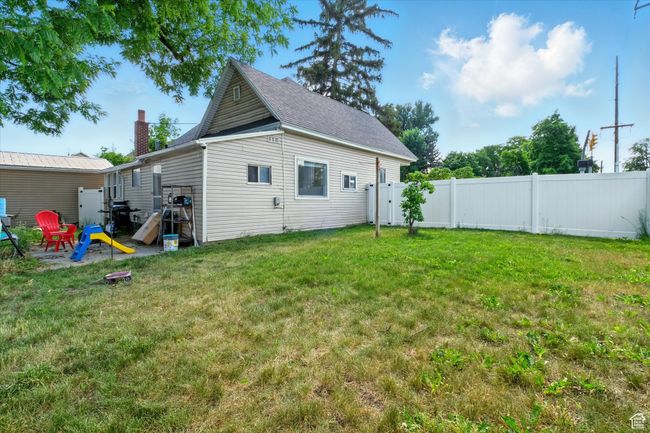 Rear view of house with a chimney and roof with shingles | Image 18