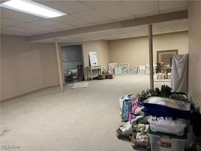 Finished side of the Basement is carpeted and has a paneled ceiling. | Image 36