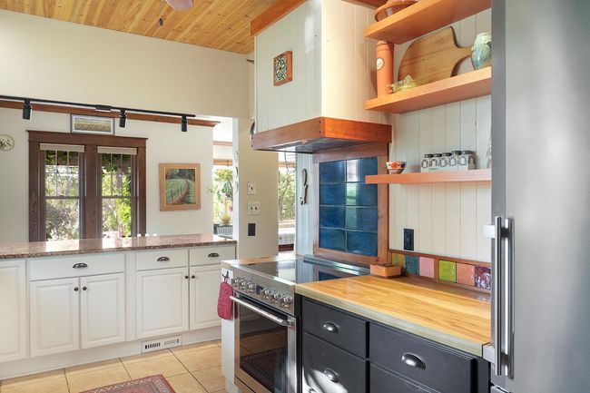 Newer appliances, extensive storage and acres of counter space make meal prep and entertaining a joy. | Image 12