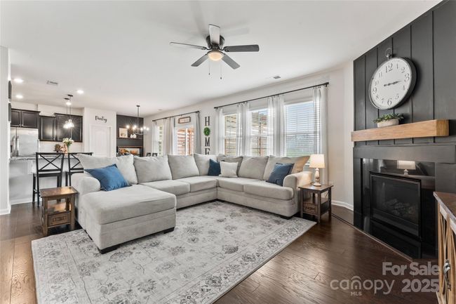 Family room with statement wall and gas fireplace | Image 9