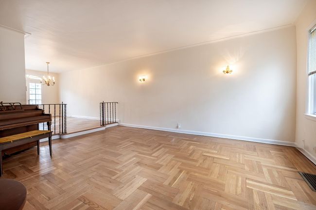 Empty room featuring visible vents, a chandelier, and baseboards | Image 5