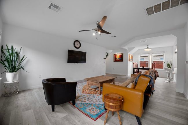 Living room featuring ceiling fan and light wood-style flooring | Image 5