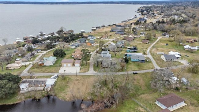 Aerial photo shows a lakeside community. The neighborhood is nestled near Lake Livingston, offering scenic views and a relaxed atmosphere ideal for a tranquil lifestyle. | Image 41