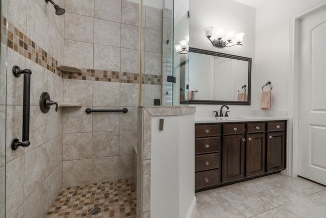 Full bath featuring a tile shower and vanity | Image 16