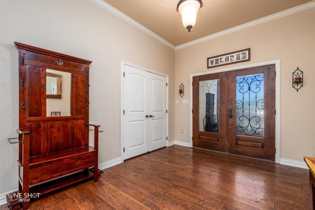 Entryway with french doors, ornamental molding, wood finished floors, and baseboards | Image 6