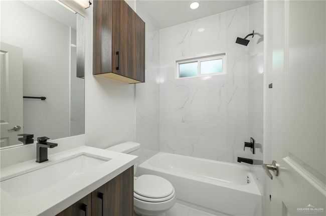 Full bath featuring toilet, shower / bath combination, vanity, and recessed lighting | Image 17