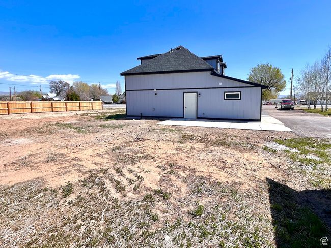 Rear view of house with fence and roof with shingles | Image 30