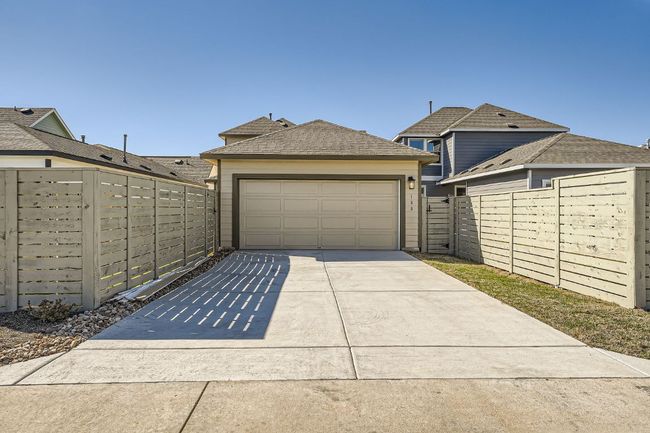 Garage featuring fence and driveway | Image 28