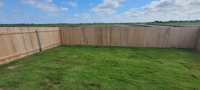 View of fenced backyard | Image 18