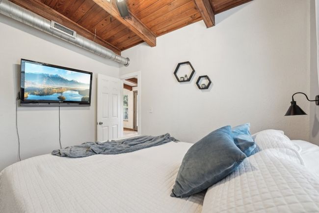 Bedroom featuring wooden ceiling with exposed beams | Image 23