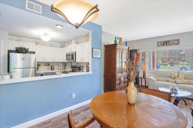 Dining room with wood finished floors and baseboards | Image 6