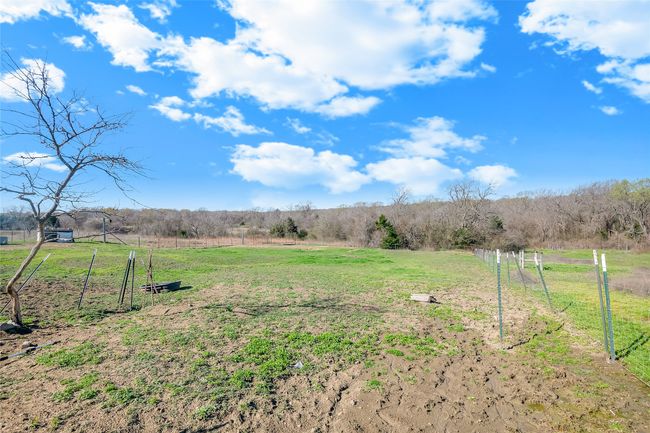 View of yard with a rural view and fence | Image 38
