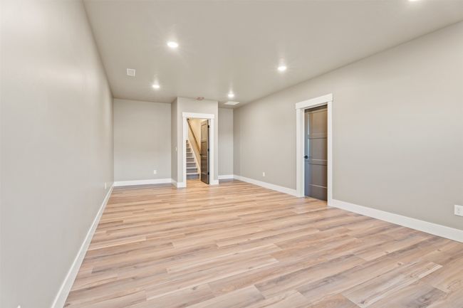 Spare room with recessed lighting, light wood-style floors, stairs, and baseboards | Image 36