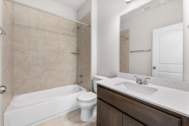 Bathroom with vanity, tile patterned floors, toilet, visible vents, and shower / bathing tub combination | Image 27