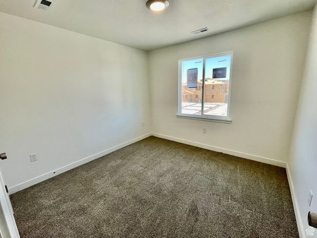 Unfurnished room with dark carpet and baseboards | Image 15